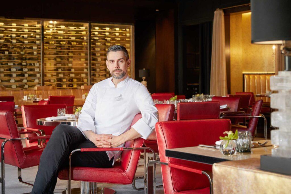 Man sitting on red Chair