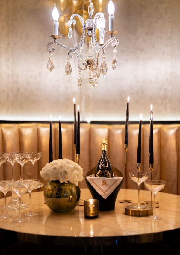 a table topped with wine glasses and a bottle of wine