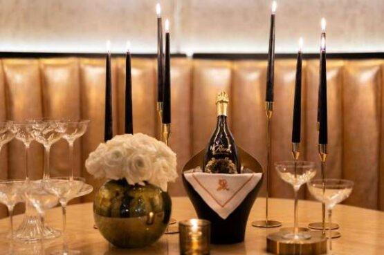 a table topped with wine glasses and a bottle of wine