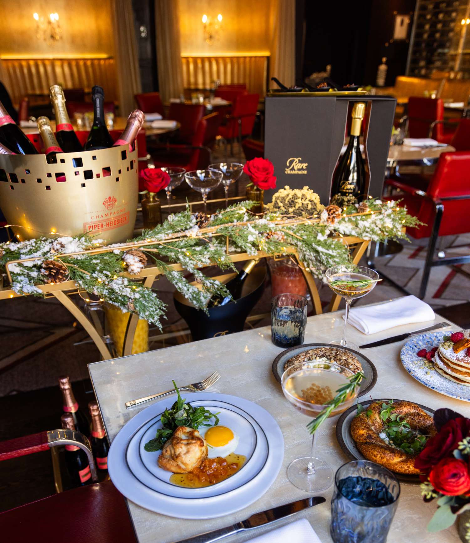 a table topped with plates of food next to a bottle of wine